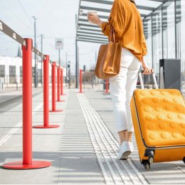 LIMIT red retractable belt stanchion, full view with extended black belt and round base
