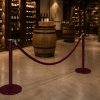 Poteau a corde (bordeaux laque) avec cordon bordeau installés dans une cave vinicole